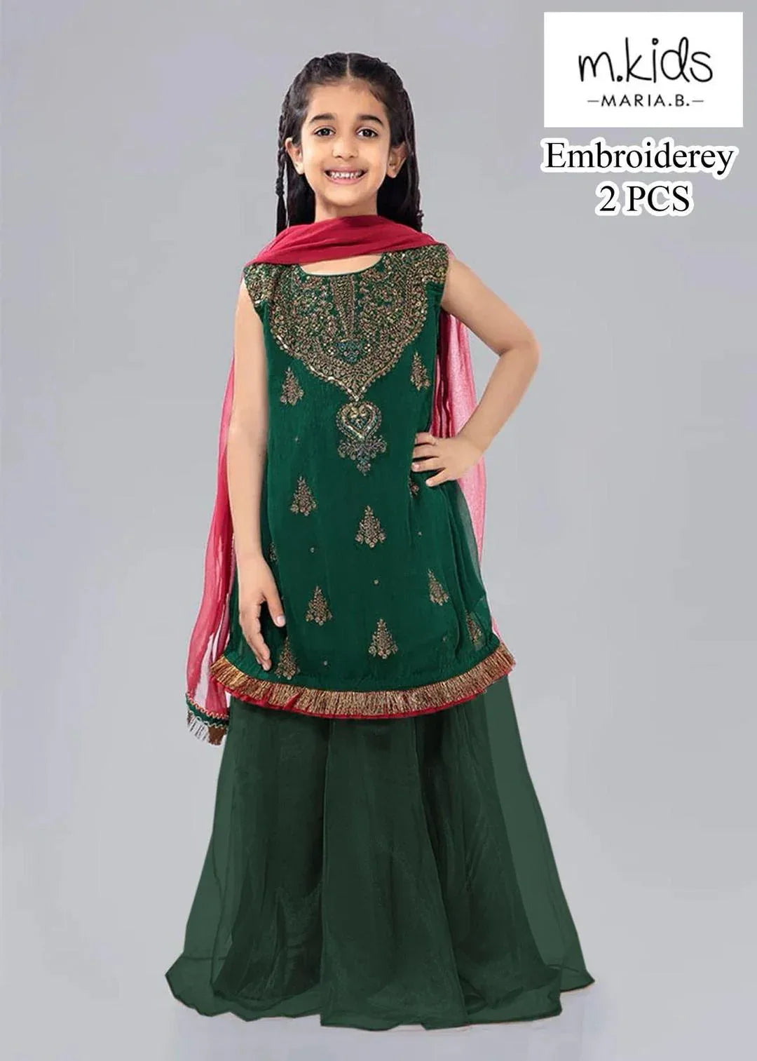 Young girl wearing a green embroidered outfit with a pink dupatta, standing against a gray background. Brand 'mkids' visible.