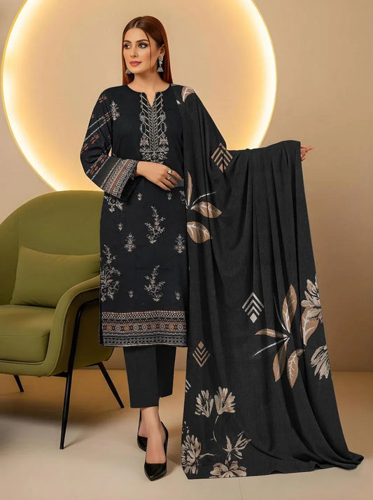 Woman holding a black embroidered dupatta with floral patterns in a minimalistic setting.