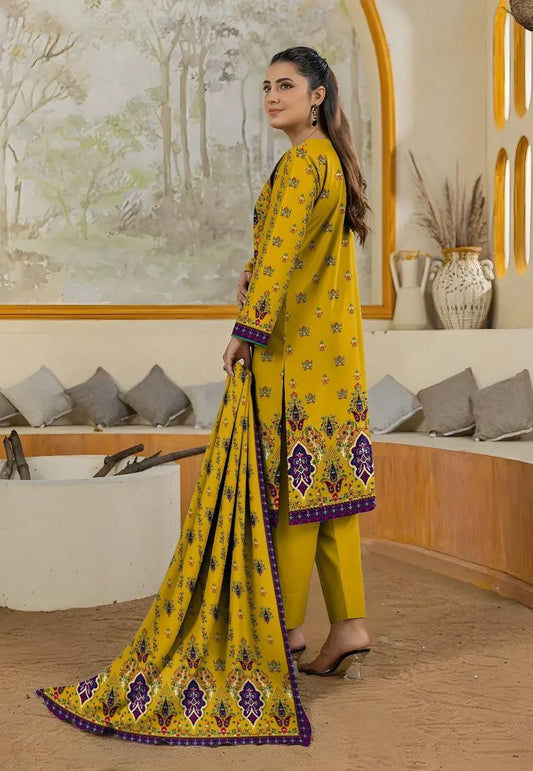 Woman in a yellow traditional outfit with floral patterns in an indoor setting.