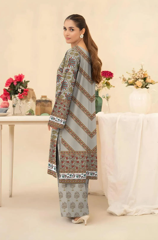 Woman wearing a traditional outfit with floral patterns in a decorated room.