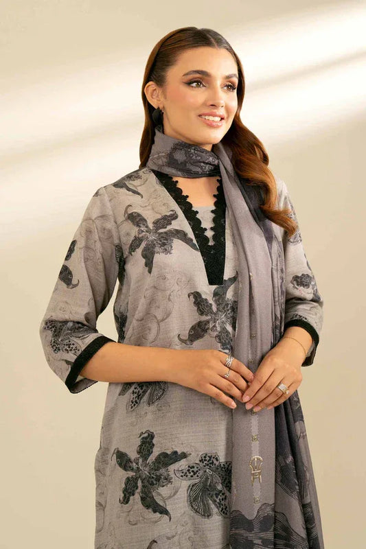 Woman wearing a gray floral-patterned scarf on a beige background