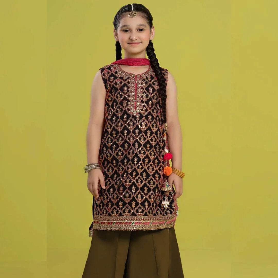 Young girl wearing a patterned dress against a yellow background