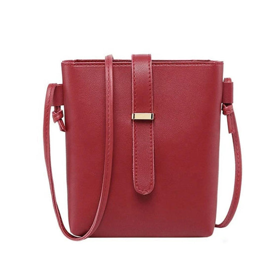Red handbag with a strap on a white background