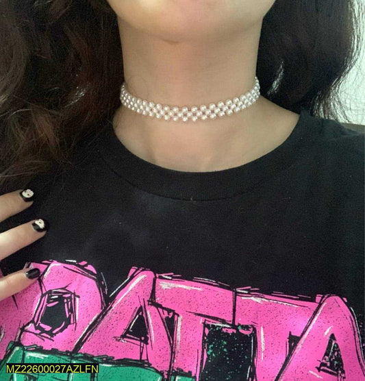 Person wearing a black shirt with pink text and a silver choker.