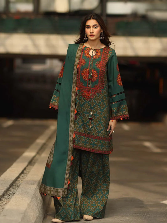 Woman wearing a traditional outfit with a green and red design in an urban setting.