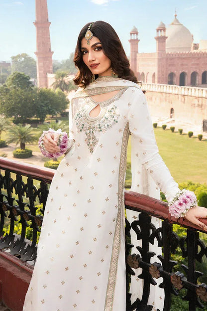 Woman in a white embroidered outfit with floral accessories standing in front of a historical building.
