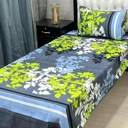 Floral patterned bedspread on a bed with matching pillows in a bedroom setting.