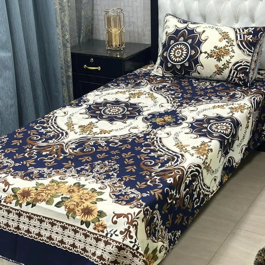 Decorative bedspread with floral and paisley patterns on a bed in a bedroom setting.