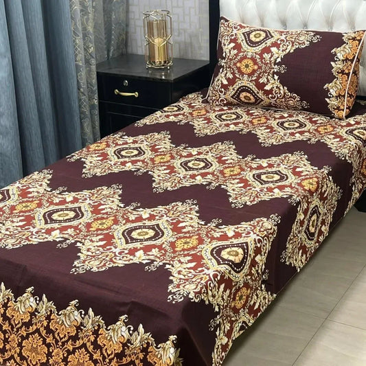 Decorative bedspread with intricate patterns on a bed in a bedroom setting.