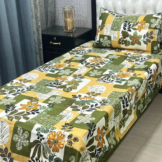 Bed with floral patterned bedspread and matching pillows in a bedroom setting.