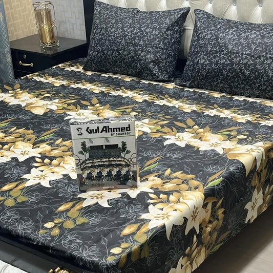 Floral patterned bedspread on a bed with a 'Gul Ahmed' box in the foreground.