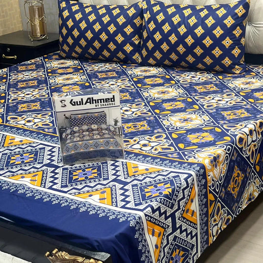 Bedspread with blue and yellow patterns on a bed, featuring Gul Ahmed branding.