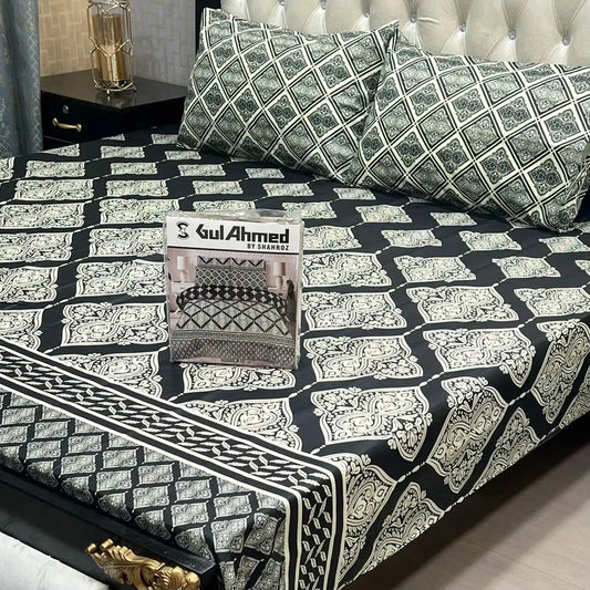 Patterned bedspread with a visible brand logo on a bed