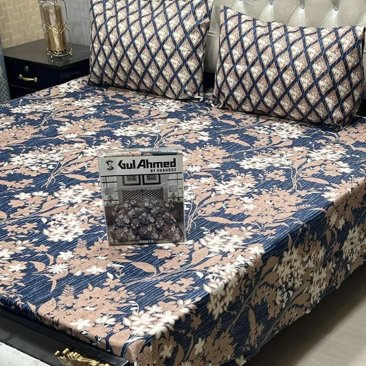 Floral patterned bedspread on a bed with 'Gul Ahmed' branding.