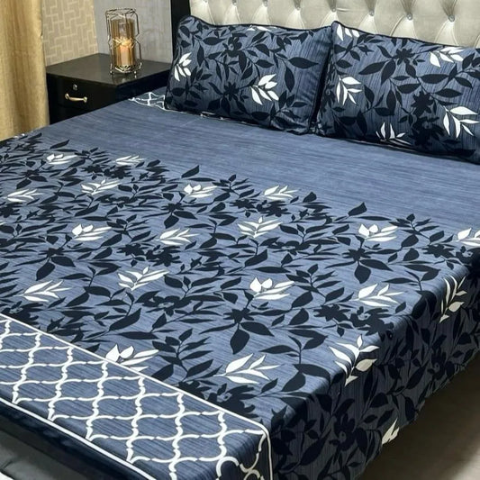 Floral patterned bedspread on a bed with matching pillows.