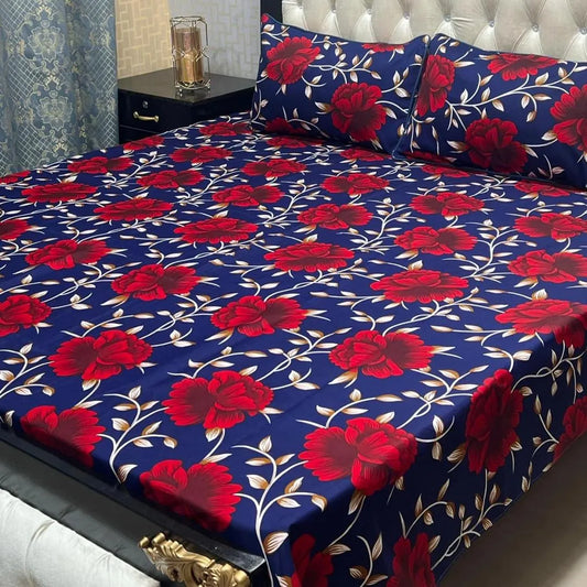 Floral bedsheet set with red flowers on a blue background, placed on a bed.