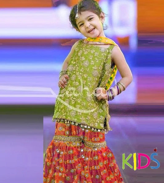 Child in colorful traditional outfit on a stage with 'KIDS' text