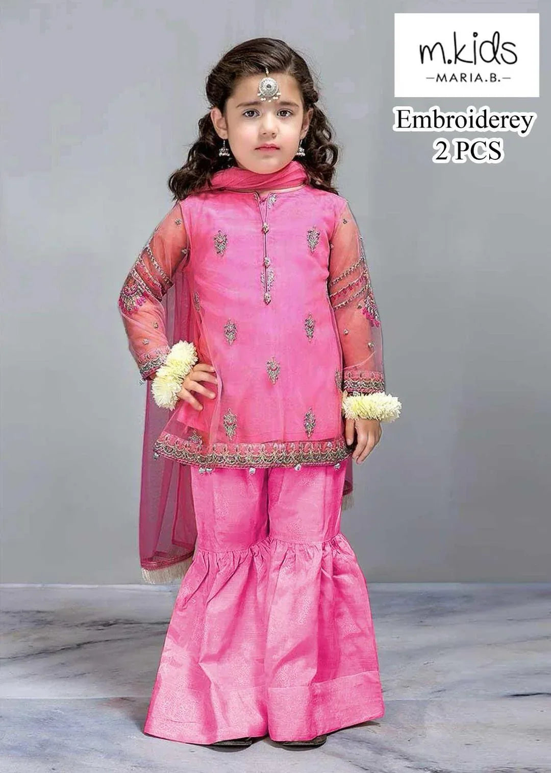 Young girl wearing a pink embroidered traditional outfit with 'm.kids' branding.