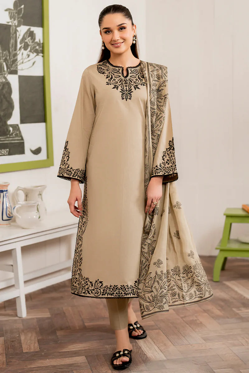 Woman wearing a beige embroidered outfit with a matching dupatta in a room setting.