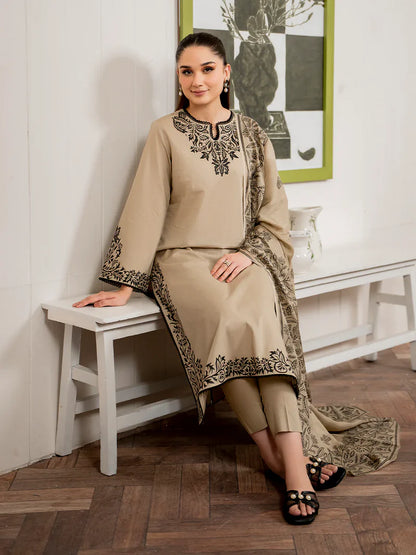 Woman in a beige traditional outfit with black embroidery sitting on a white bench.