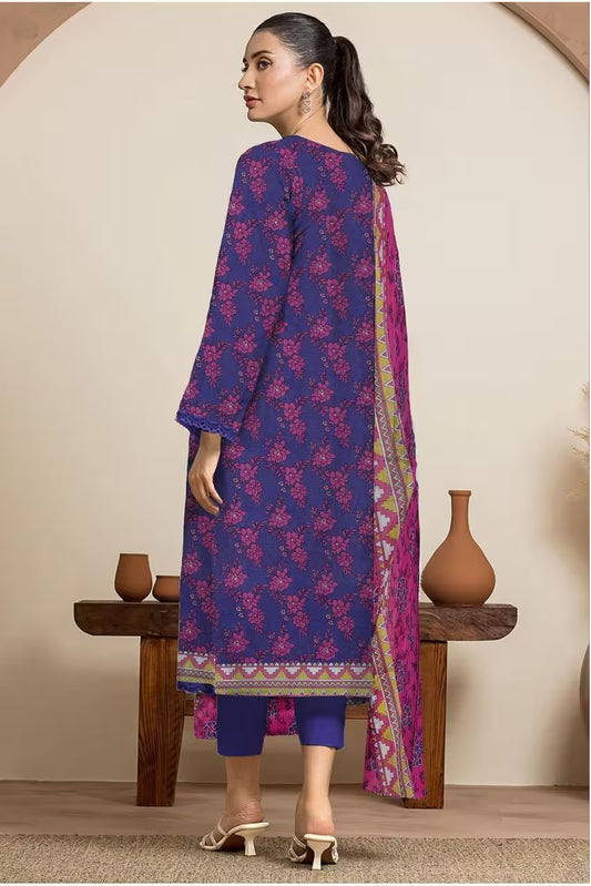 Woman wearing a blue and pink traditional outfit with a matching dupatta, standing against a neutral background.