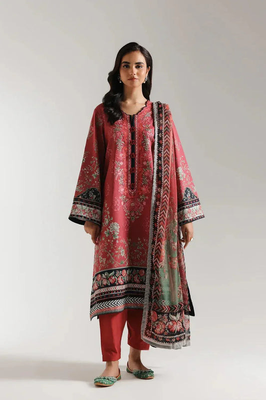 Woman wearing a red floral dress with a matching dupatta on a white background