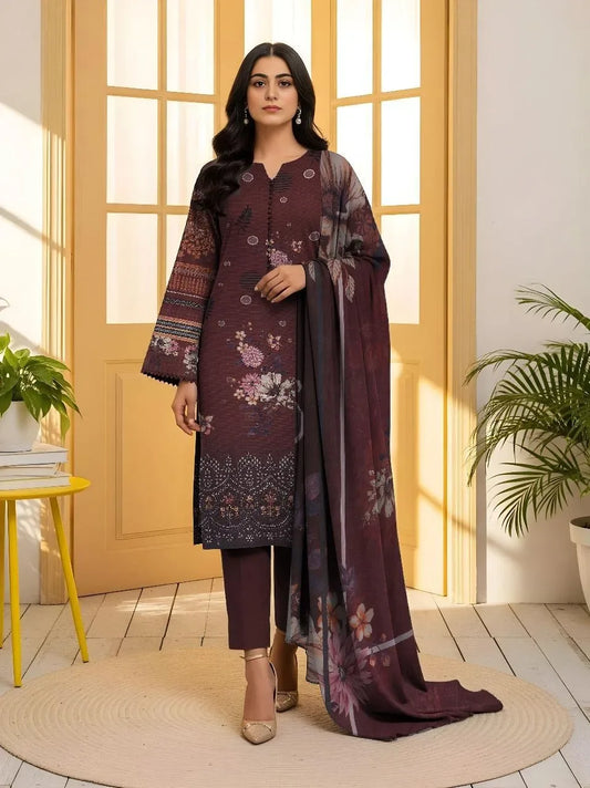 Woman wearing a dark purple embroidered outfit with a matching dupatta in a bright room.