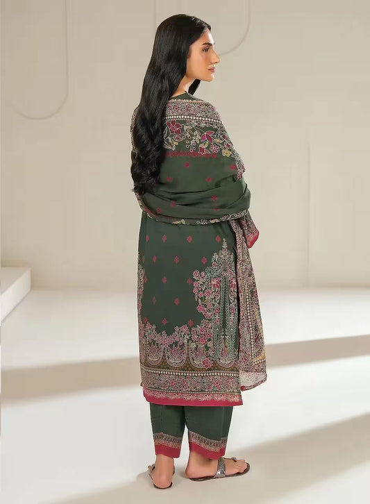 Woman wearing a green traditional outfit with floral patterns in a minimalistic setting