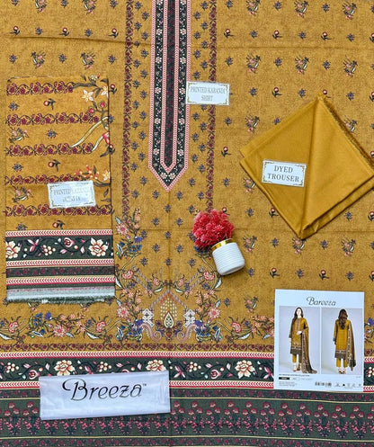 Traditional fabric with intricate patterns and 'Breeza' branding, featuring a small pot and a printed outfit image.