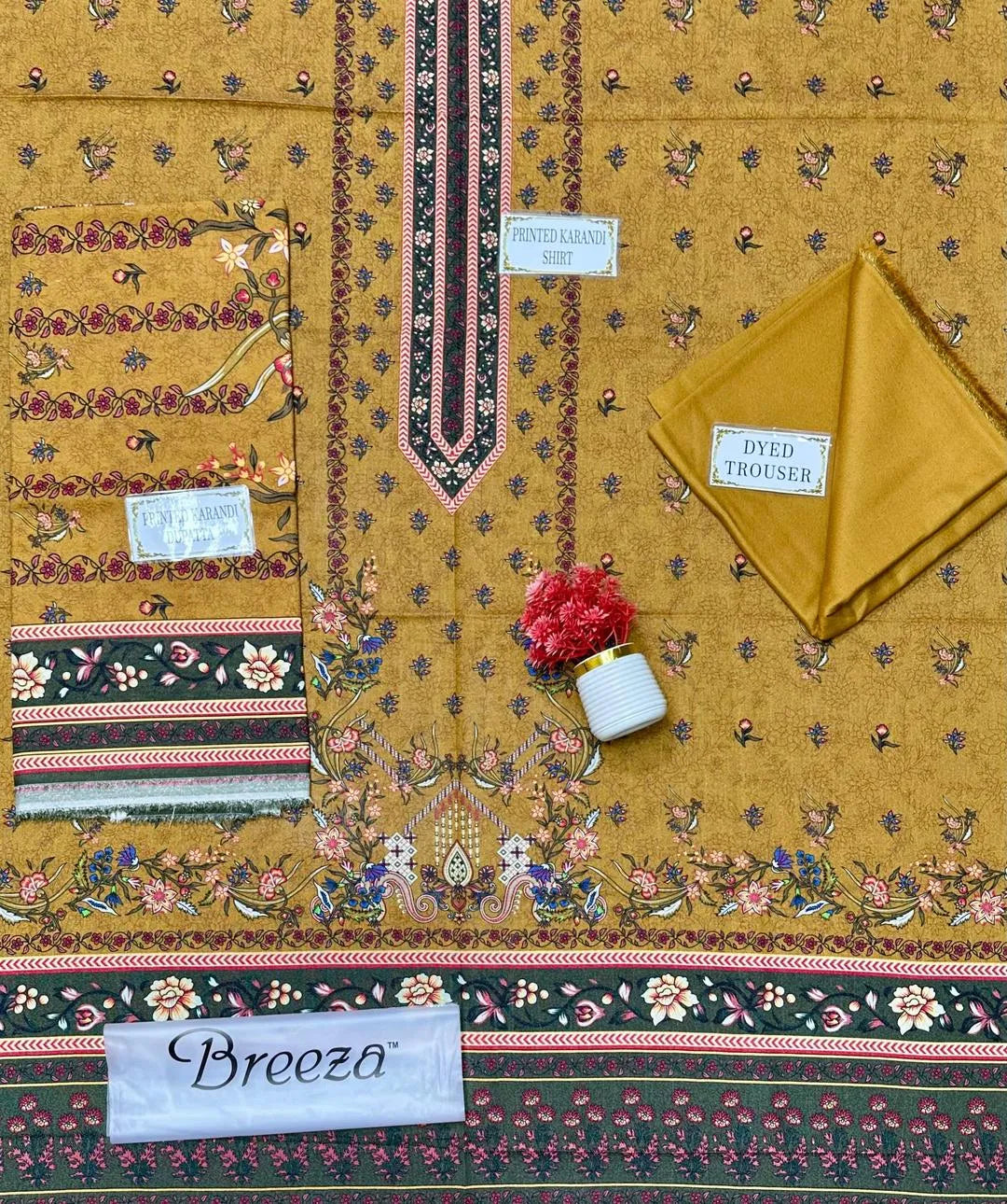 Textile with intricate patterns and 'Breeza' branding on a yellow background