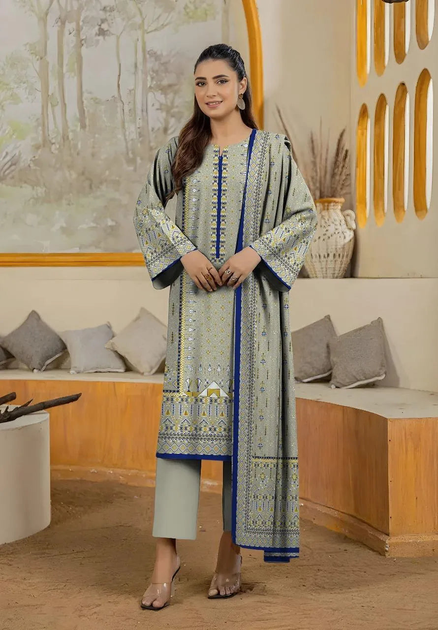 Woman wearing a traditional outfit with a patterned shirt and pants in an indoor setting.