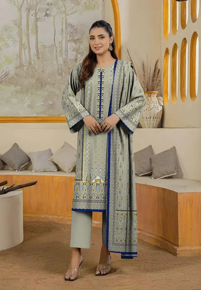 Woman wearing a traditional outfit with a patterned shirt and pants in an indoor setting.
