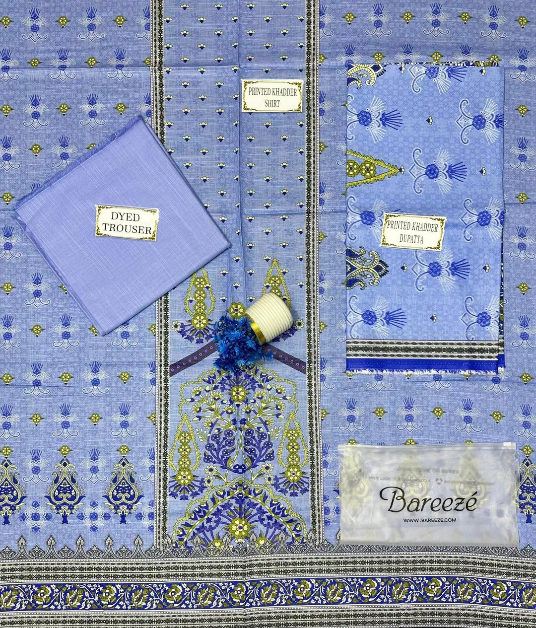 Barocco fabric with intricate patterns and a visible brand label on a matching background.