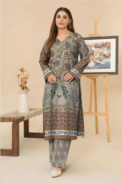 Woman wearing a floral patterned kurta with pants in a minimalistic room.