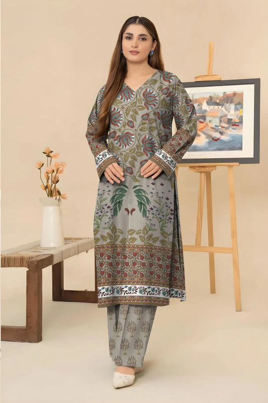 Woman wearing a floral patterned kurta with pants in a minimalistic room.