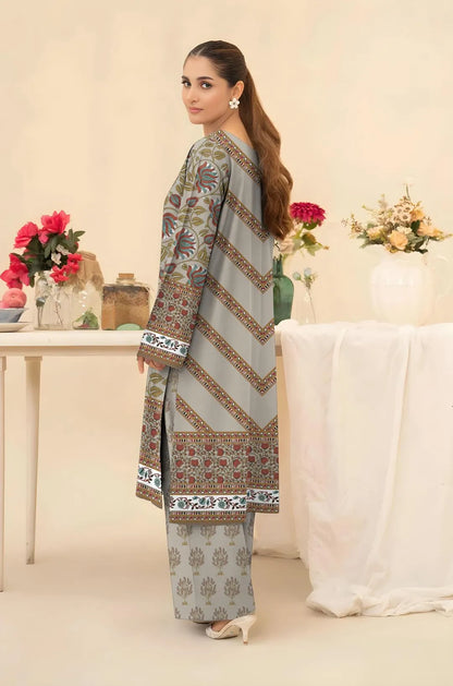 Woman wearing a traditional outfit with floral patterns in a decorated room.