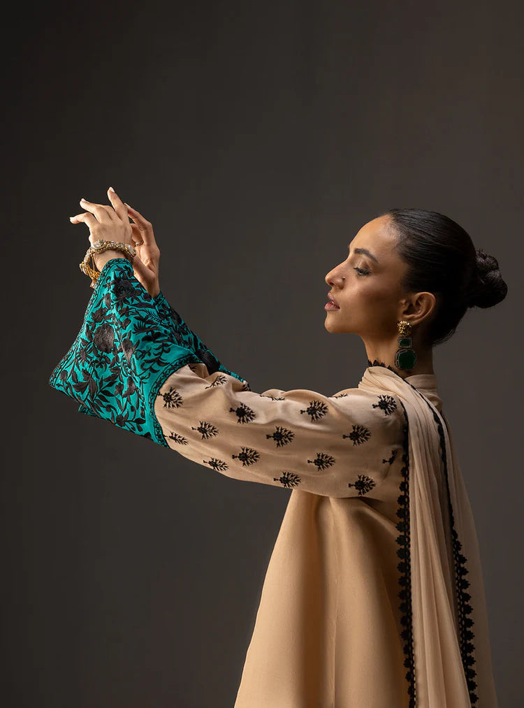 Woman in traditional attire with a dark background