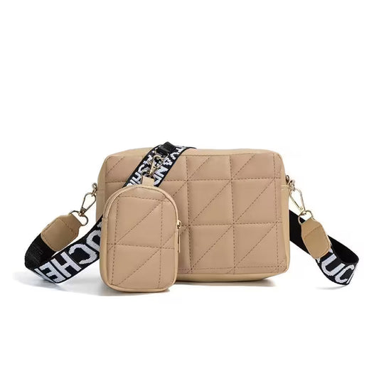 Beige quilted handbag with a matching pouch and branded strap on a white background