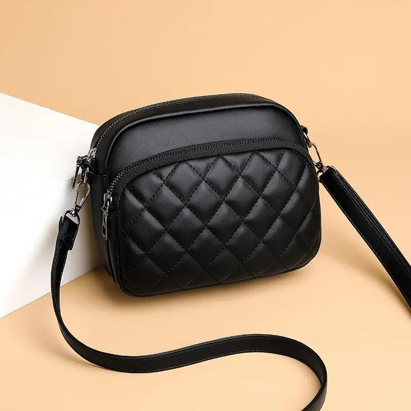 Black quilted handbag on a beige background