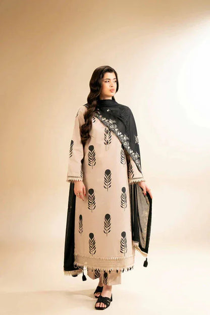 Woman wearing a beige and black traditional outfit with a matching scarf on a beige background