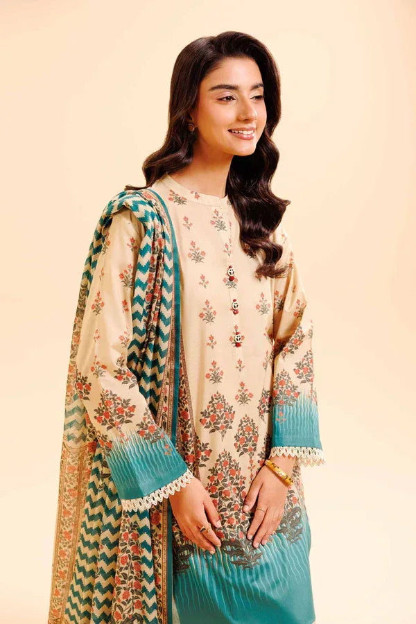 Woman wearing a floral dress with a matching dupatta on a beige background