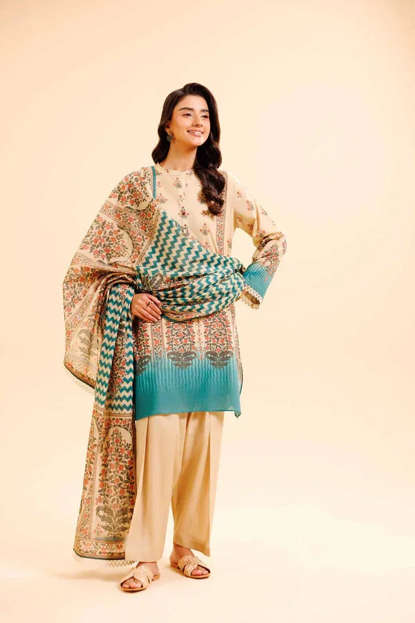 Woman wearing a traditional outfit with a patterned shawl and blue dupatta on a beige background