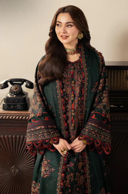 Woman wearing a traditional outfit with intricate patterns in a vintage setting.