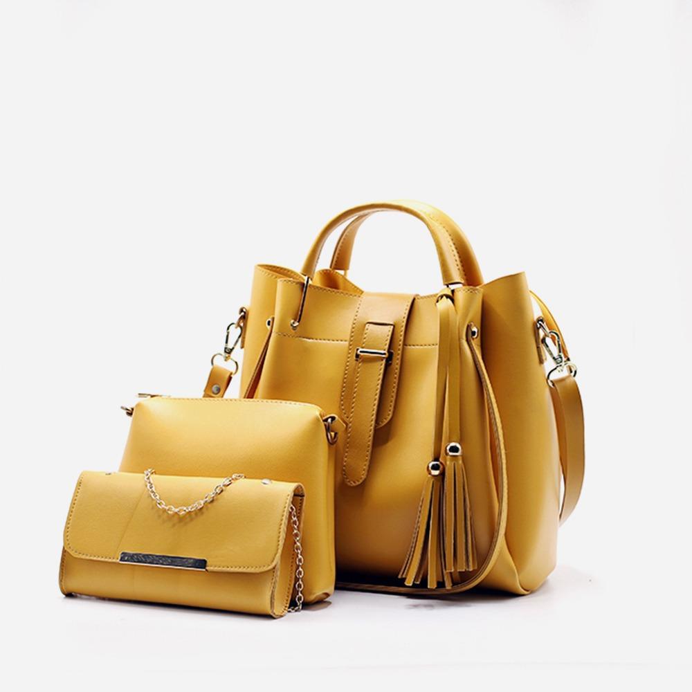 Yellow handbag and matching pouch on a white background