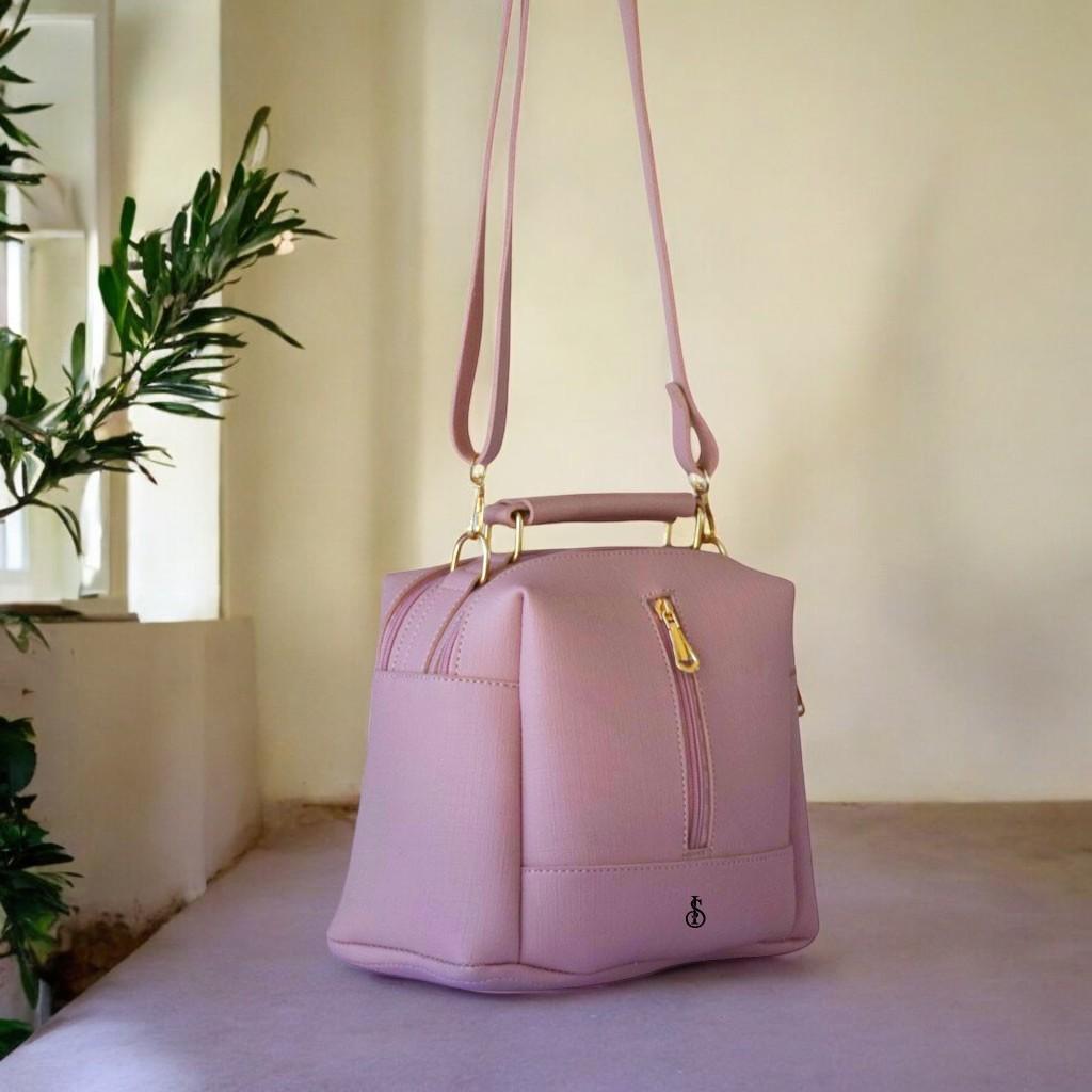 Pink handbag on a surface with a neutral background