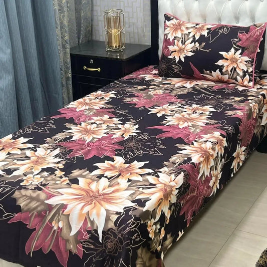 Floral bedspread on a bed with matching pillows in a bedroom setting.