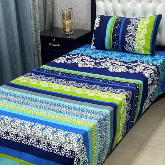 Bed with blue and green floral patterned bedding in a bedroom setting.
