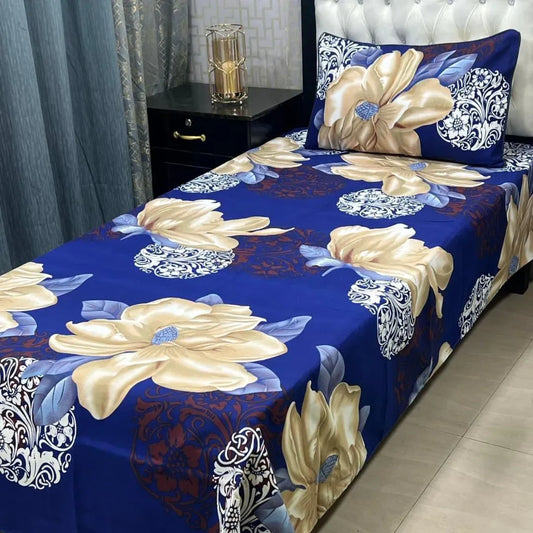 Floral patterned bedspread on a bed with decorative pillows in a bedroom setting.