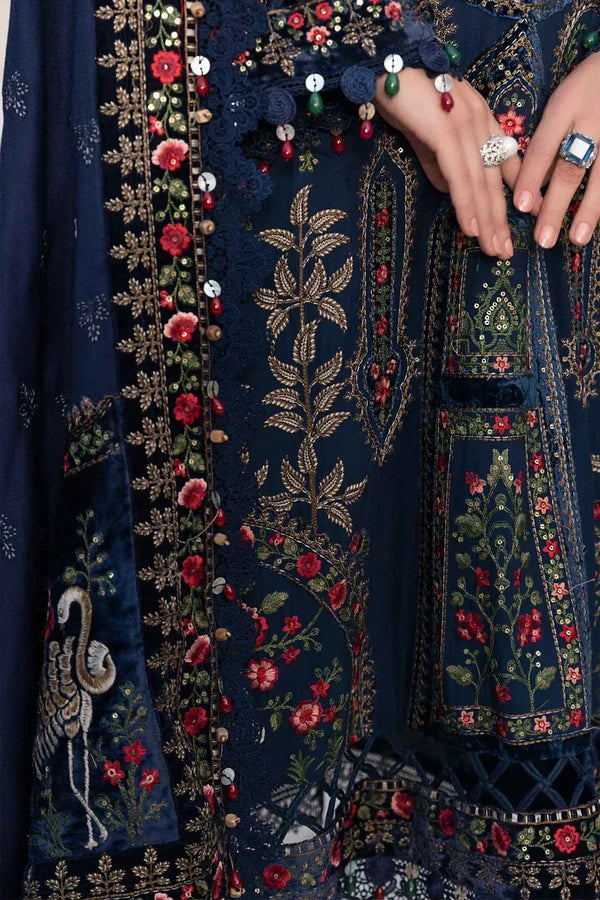 Navy blue fabric with intricate gold, red, and green embroidery
