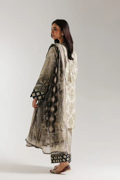 Woman wearing a traditional outfit with intricate patterns on a plain background